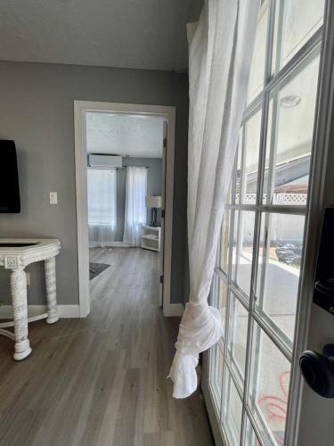 a living room with a view of a room with a window at Peaceful Forest Shadow in Humble