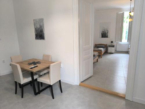 a dining room with a wooden table and chairs at Georgi 2 in Subotica