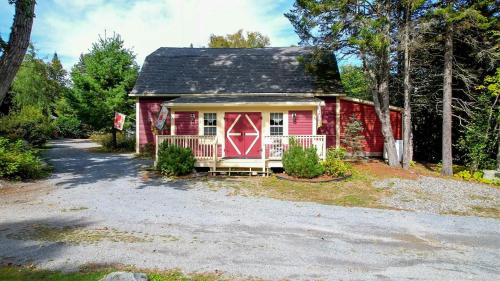 a red house with a black roof at Dominion Hill Country Inn in Bocabec