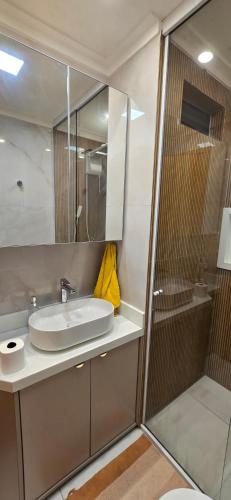 a bathroom with a sink and a shower at Belém COP30 Apartment in Belém