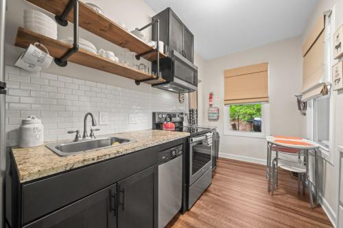 a kitchen with a sink and a counter at Mountain Bungalow-Walk to Downtown/Biker's Dream! in Hot Springs