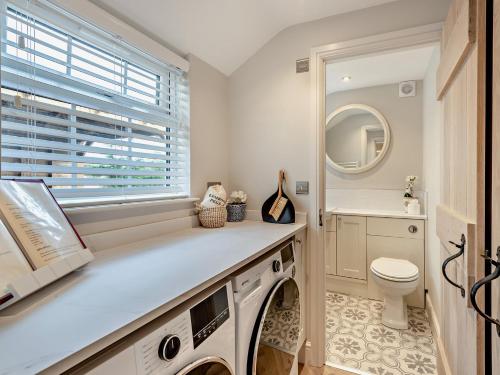 a washing machine in a bathroom with a window at 2 Bed in Cockermouth 95716 in Broughton Moor