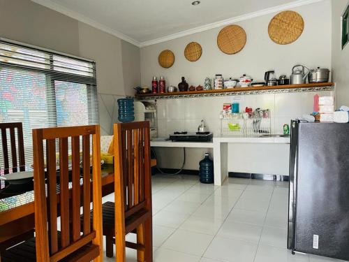 a kitchen with a counter and a table and chairs at Omah Eitan in Wonosari