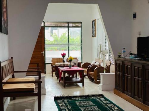 a living room with a table and some chairs at Omah Eitan in Wonosari