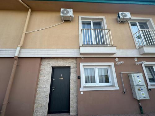 a building with a door and windows and a speaker at Terra Villa #Cosmopolis in Tunari