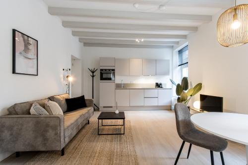 a living room with a couch and a table at City Apartments Nijmegen in Nijmegen