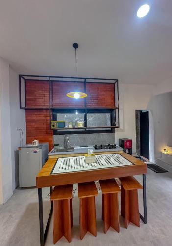 a kitchen with a large wooden table in a room at Martos house in Dieng