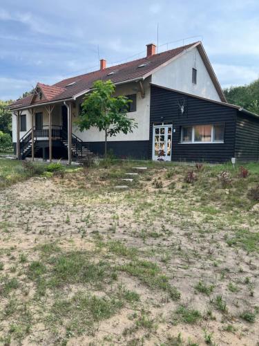 a house with a large yard in front of it at PusztaHaus Pusztavám in Mór