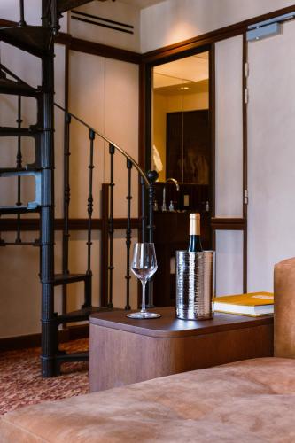 a room with a staircase and a wine glass at Hôtel Confidentiel - Louvre in Paris