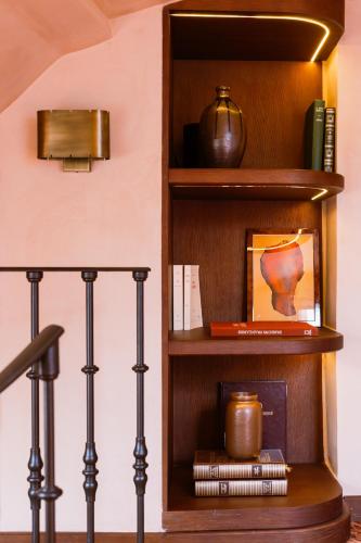 a wooden book shelf with books and a pot on it at Hôtel Confidentiel - Louvre in Paris