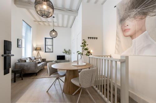 a living room with a table and chairs at City Apartments Nijmegen in Nijmegen