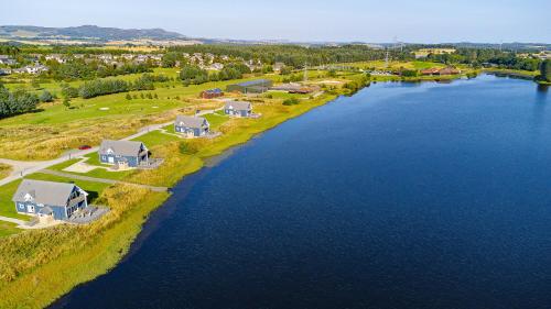an aerial view of a river with houses on the shore at Landal Piperdam in Dundee
