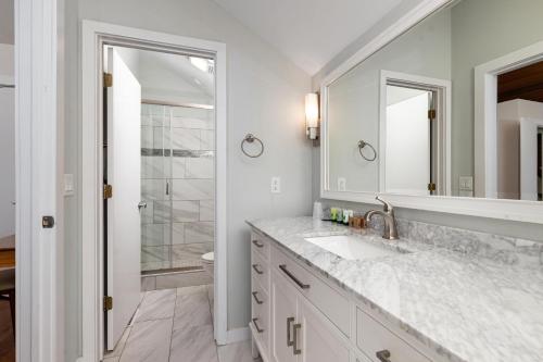 a white bathroom with a sink and a mirror at Ledges 78 with Wintergreen Advantage in Wintergreen