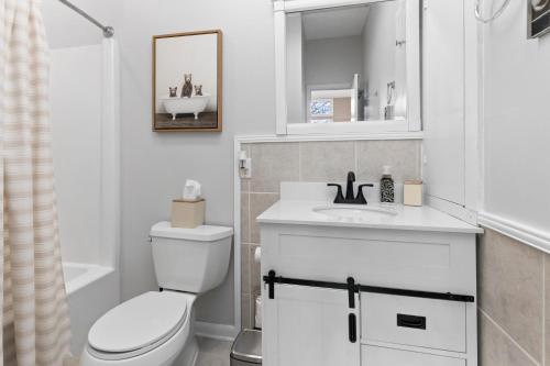 a white bathroom with a toilet and a sink at Laurelwood 48 with Wintergreen Advantage in Wintergreen