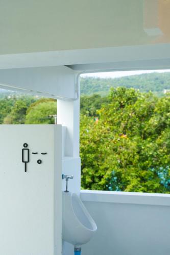 a bathroom with a sink and a window at Passerby hostel samui in Amphoe Koh Samui