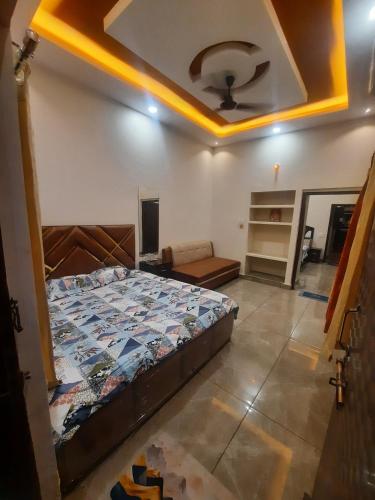a bedroom with a bed in a room at Raj Laxmi Homestay in Ujjain