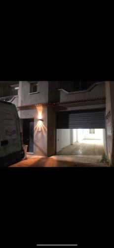 a view of a building with a parking garage at 3 appartements Niveau de villa avec garage 