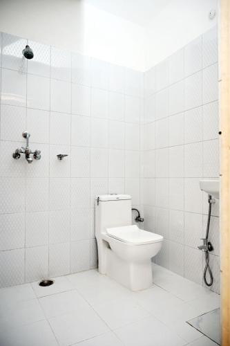 a bathroom with a toilet and a sink at New Kashi darshan Family and group guest house in Varanasi
