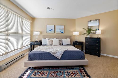 a bedroom with a bed with two night stands and two windows at Shenandoah Ridge 05 with Wintergreen Advantage in Wintergreen