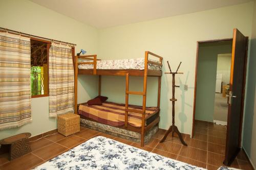 a bedroom with two bunk beds in a room at Chácara with pool and trails in the Cerrado biome in São Carlos