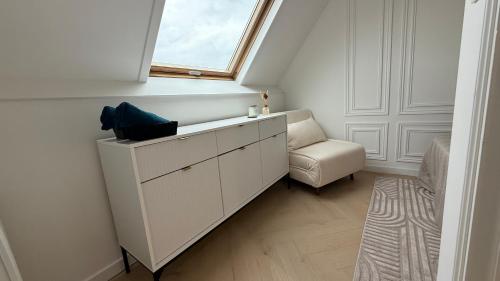 a white room with a window and a chair at Apartment Orléans in Orléans