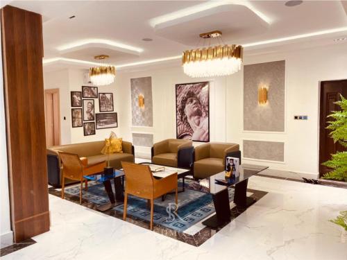 a living room with couches and a table at Sujimoto Shortlet Ave Forche, Banana Island, Ikoyi in Ikoyi