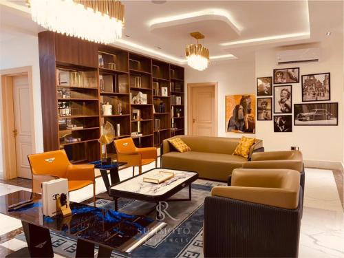 a living room with a couch and chairs and a table at Sujimoto Shortlet Ave Forche, Banana Island, Ikoyi in Ikoyi