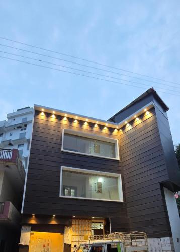 a house with lights on the side of it at Hotel KG Tapovan Hills in Rishīkesh