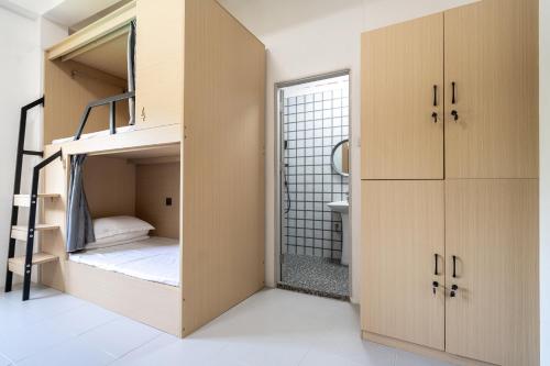 a small room with bunk beds and a bathroom at Passerby hostel samui in Amphoe Koh Samui