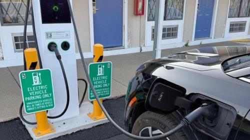 a electric vehicle is being charged at a gas station at Motel 6-Hamburg, NY in Hamburg