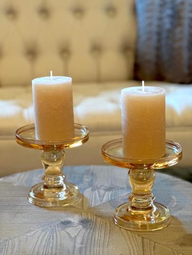 two candles sitting on top of a table at Chalet-Simmi in Wimmis
