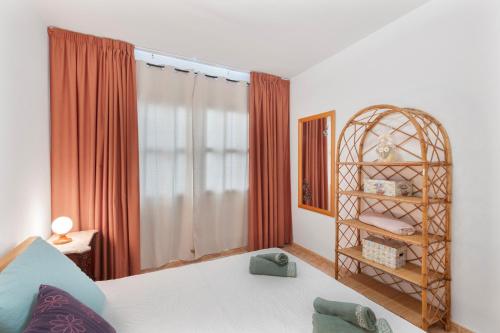 a bedroom with a bed and a book shelf at Home Elias La Palma City in Santa Cruz de la Palma