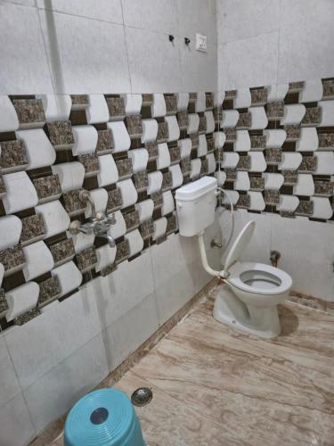 a bathroom with a toilet in a room at Hotel Taj Moon in Tājganj
