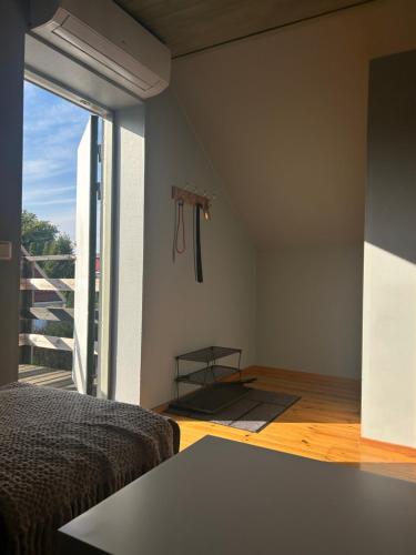 a bedroom with a bed and a large window at Private & Secluded Apartment in Mörrum - with Parking, Wi-Fi & Secluded Outdoor Area in Mörrum