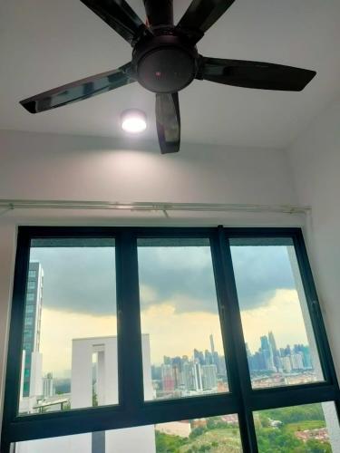 a ceiling fan in a room with a window at The Valley, SkySierra KL in Kuala Lumpur