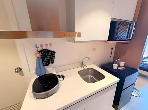 a kitchen with a sink and a toaster on a counter at Cozy and Classy Monaco Suite Mt Arayat View in San Fernando