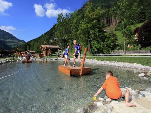 a group of children on a bridge in the water at Apartment in Hüttschlag near Ski Bus in Hüttschlag