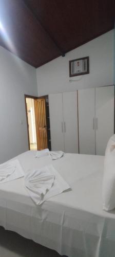 En eller flere senge i et værelse på Portal - praia taperapuan