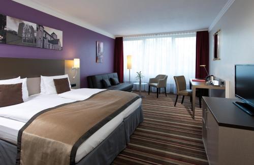 Ένα ή περισσότερα κρεβάτια σε δωμάτιο στο Leonardo Hotel Mönchengladbach
