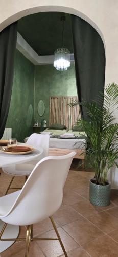 a bedroom with a bed and a table and a plant at Antica in Savona