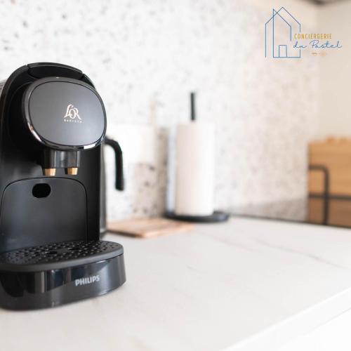 a coffee maker sitting on top of a counter at AU XV Sainte Cécile T2 Art Déco in Albi