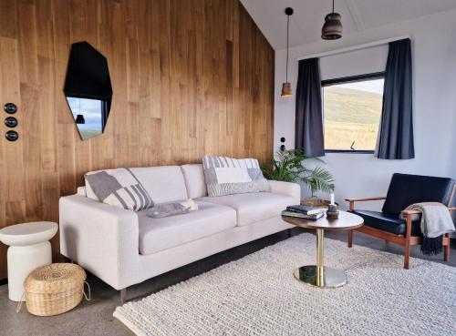 a living room with a white couch and a table at Svartaborg in Húsavík