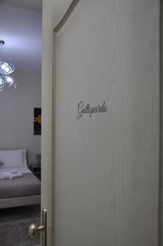 a door to a room with a bed and a mirror at B&B La Terrazza Degli Scrittori in Racalmuto