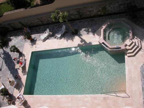 an overhead view of a swimming pool with two lawn chairs at Hotel Torretta in Montecatini Terme