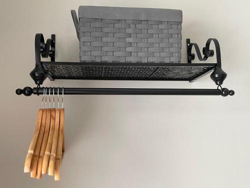 a black metal shelf with a bunch of bats at 3 Stable Mews in Holsworthy