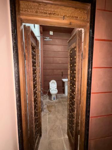 a bathroom with a toilet in a room at Marwar Mosaic Heritage Haveli in Jodhpur