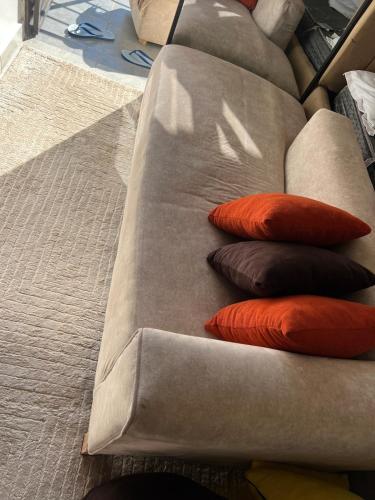 a group of pillows sitting on a couch at A cozy spacious studio apartment with a balcony in Nairobi
