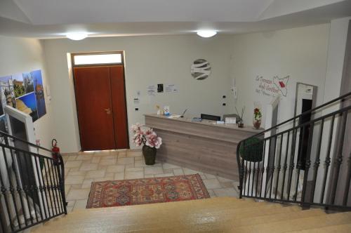a hallway with a lobby with a counter and a door at B&B La Terrazza Degli Scrittori in Racalmuto