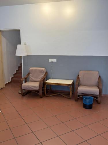 a waiting room with two chairs and a table at Heeren Street Boutique Hotel at Jonker Walk in Melaka