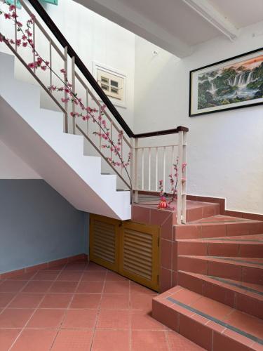 a staircase in a house with pink flowers on it at Heeren Street Boutique Hotel at Jonker Walk in Melaka